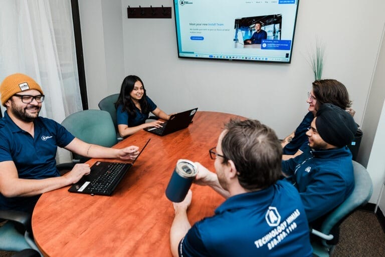 Adroit Technologies team meeting in the board room